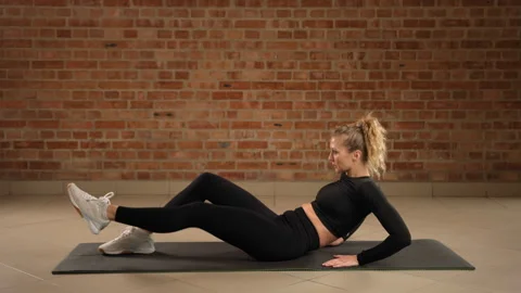 Single-leg V-tuck on Left Leg for Core Strength by Fitness Expert Stock Footage 269196547