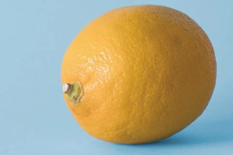 Single lemon on a blue background Stock Photos