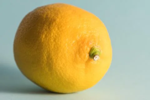 Single lemon on a blue background Stock Photos