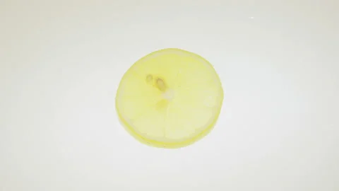 Single Lemon Slice Rotating In Stop Motion Mode On White Background Stock Footage 117912000