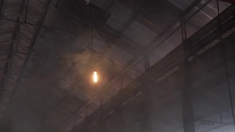 Single Light Bulb Inside Dark Industrial Warehouse Stock Footage 324560135
