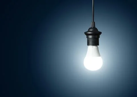 Single light bulb over blue background with copy space Stock Photos