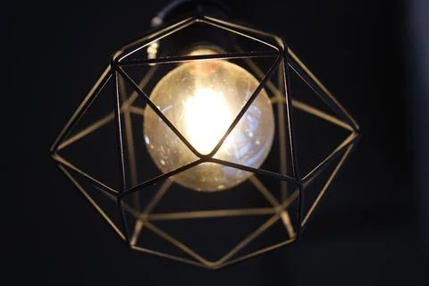 A single light source hanging from the ceiling, suitable for interior design or Stock Photos