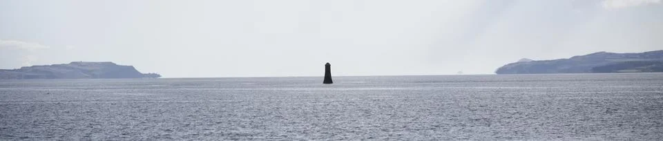 Single lighthouse mindfulness empty background with ocean and blank sky Stock Photos
