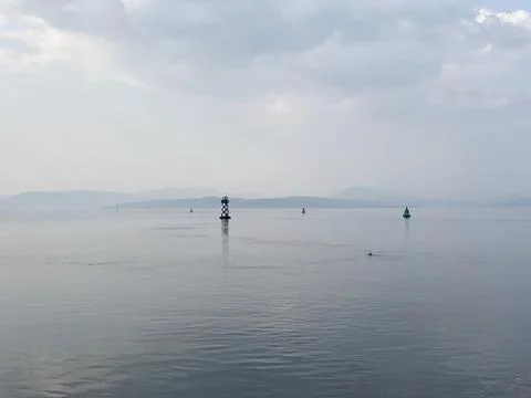 Single lighthouse mindfulness empty background with ocean and blank sky Stock Photos