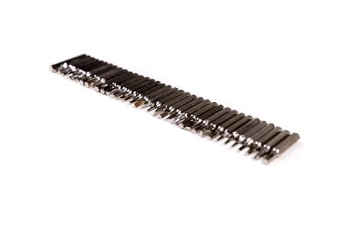 Single line of small metal interchangeable screwdriver bits for a multitool Stock Photos