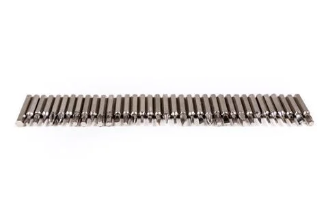 Single line of small metal interchangeable screwdriver bits for a multitool Stock Photos