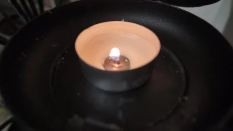 A single lit candle glowing softly inside a church Stock Footage 320243580