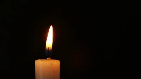 Single lit candle with quite flame Stock Footage 82400123