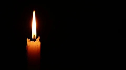 Single lit candle with quite flame Видео 84308585