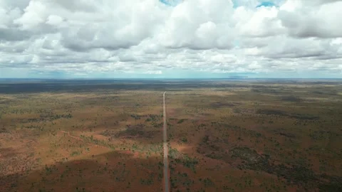Single lone empty road through the flat red outback Stock Footage 274961419