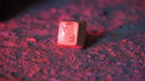 Single, Lost Keyboard Key on a Dark, Red-Lit Surface Video stock 297529636