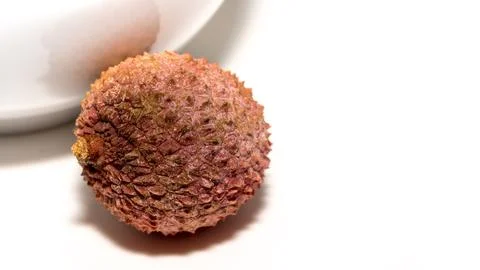 Single lychee fruit, against a white background, detail-taking Stock Photos