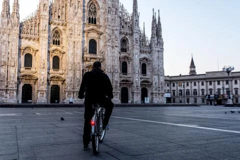 Single man on bicycle standing alone in front of Milan's Cathedral, Duomo MIl Stock Photos