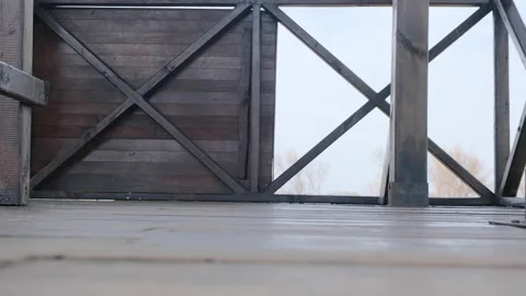 A single man on the bird watching tower and walking with trekking boot Video stock 152958695