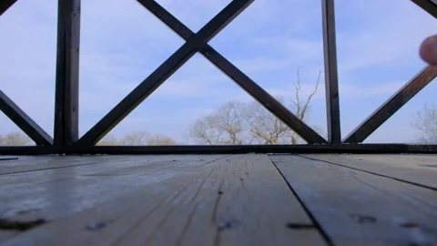 A single man on the bird watching tower and walking with naked foot Video stock 152958807