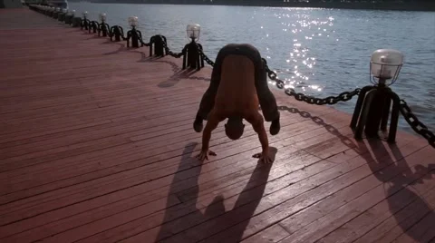 Single man does martial arts on the beach during sunset time. Wushu. Stock-Footage 66729620