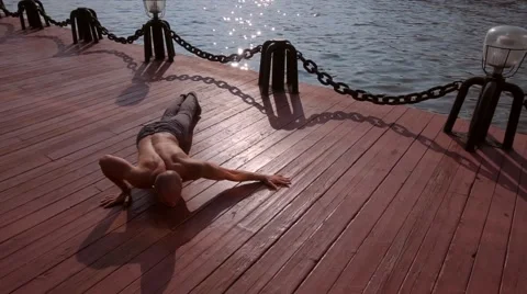 Single man does martial arts on the beach during sunset time. Wushu. Stock Footage 66729731