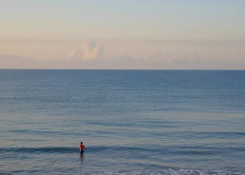 Single Man Fishing in Ocean Surf Stock Photos