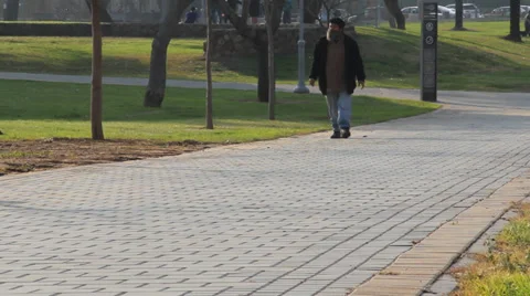 Single man walking in the park Stock Footage 33790305