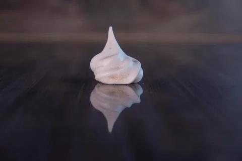 Single meringue on black background Stock Photos