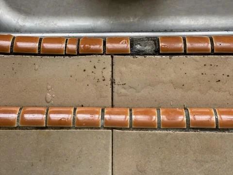 Single Missing Tile On Kitchen Countertop Edge Near Stainless Steel Sink Stock Photos