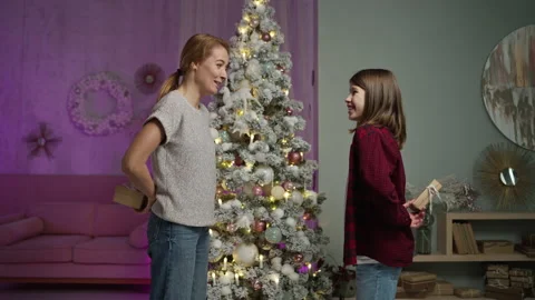 Single mother exchanges New Year's gifts with long-haired teen guy in room Video stock 165070409