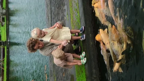 Single mother spending weekend time with twin daughters together, feeding Stock Footage 168746062