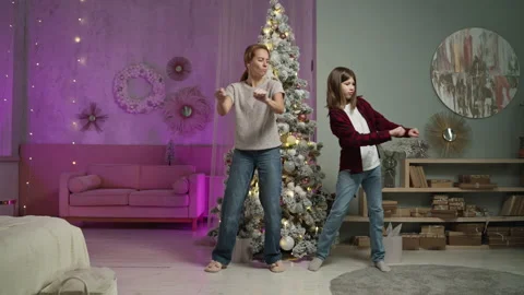 Single mother to study dance moves behind her son in room on New Year's Eve Stock Footage 165071689