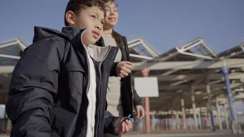 Single mother walks with her son through the city at sunset. They sing a song Stock Footage 149055037