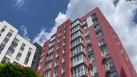 Single multi-storey building against a cloudy blue sky. Stock Footage 283742436