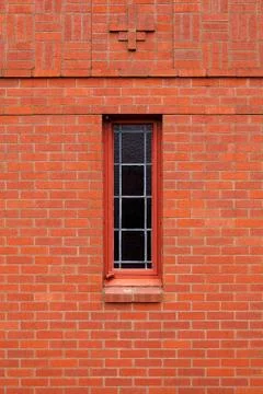 Single narrow window in brick wall Stock Photos