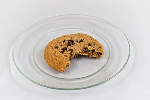 Single Oatmeal Cookie Missing a Bite on Glass Plate Stock Photos
