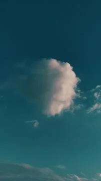 A single one big piece of white fluffy  cloud in the blue sky Stock Photos
