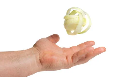 Single onion ring hovering over hand Photos