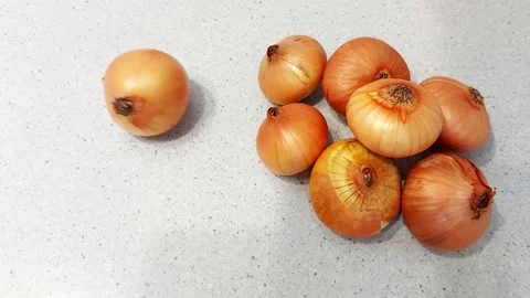 Single Onion vs Group- Visual Contrast in Kitchen Setup Stock Footage 317218086