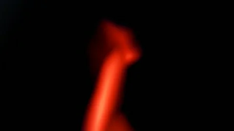 Single Orange Red Flame Flickering on Black Background Blurred Fire Stock Footage 347788620