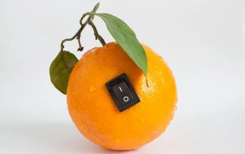 Single orange with switch in power off position on light grey background Stock Photos