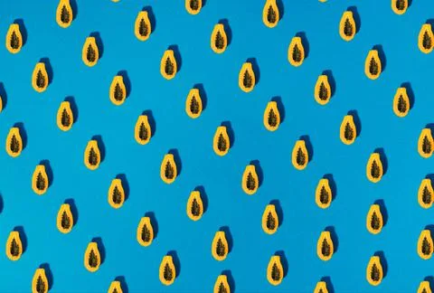 Single papaya fruit cutter on half on blue background Stock Photos