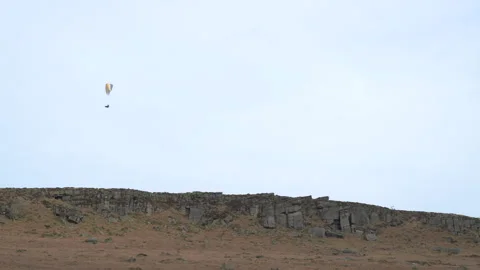A single paraglider at Stanage Edge in the Derbyshire Peak District during .. Video stock 264097286