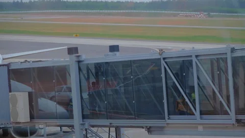 Single passenger boarding on airplane through an glass airbridge. Stock Footage 97490443