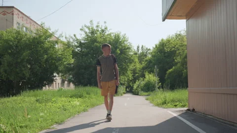 Single Person Ambles Through Tranquil Neighborhood Under Soft Light, Solitary Stock-Footage 324612175