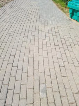 Single perspective of gray brick pavement pathway in an outdoor park setting, Stock Photos