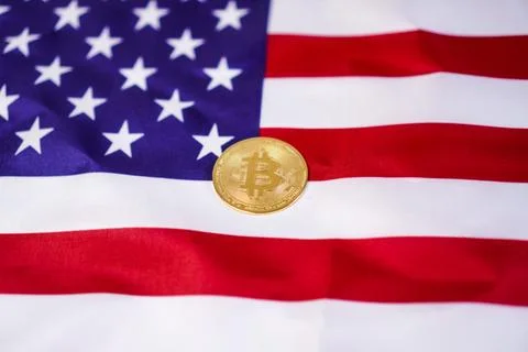 A single physical golden Bitcoin token coin of the red and white stripes, d.. Stock Photos