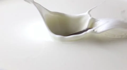 Single piece of chocolate falling into milk. Super slow motion macro shot Stock Footage 60229167
