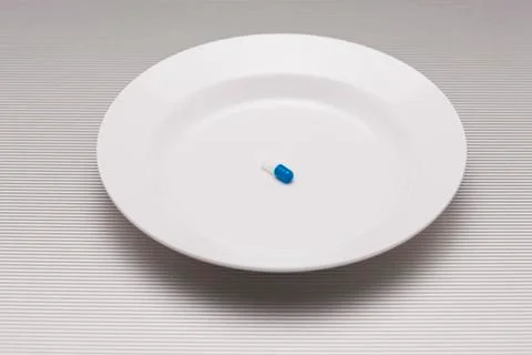 Single pill on plate Stock Photos