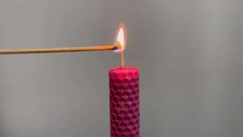 Single pink candle burning. Shot. Isolated on white background candle burning Stock Footage 256316897