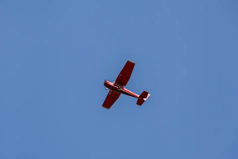 Single piston aircraft. Single-propeller aircraft flying over the blue sky Stock Photos