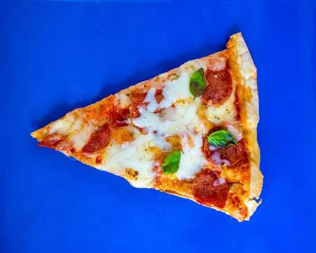 Single Pizza Slice Pepperoni Cheese Blue Background Top Down Stock Photos