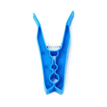 Single plastic cloth peg isolated over white background Stock Photos